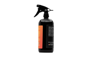 Black spray bottle with orange label on a white background